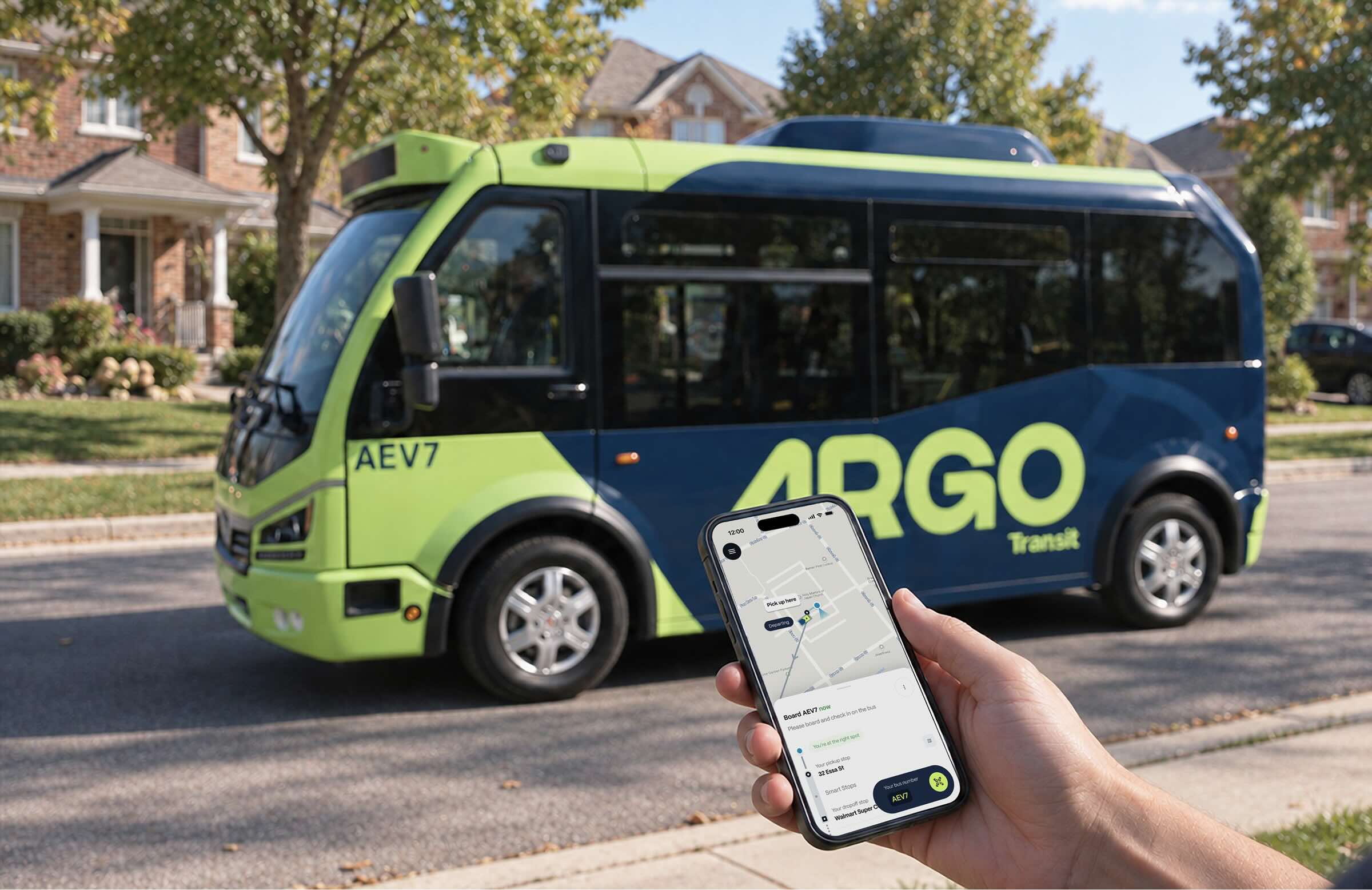 A rider’s phone shows the Argo app telling them to board bus AEV7, as the bus pulls up on a residential street